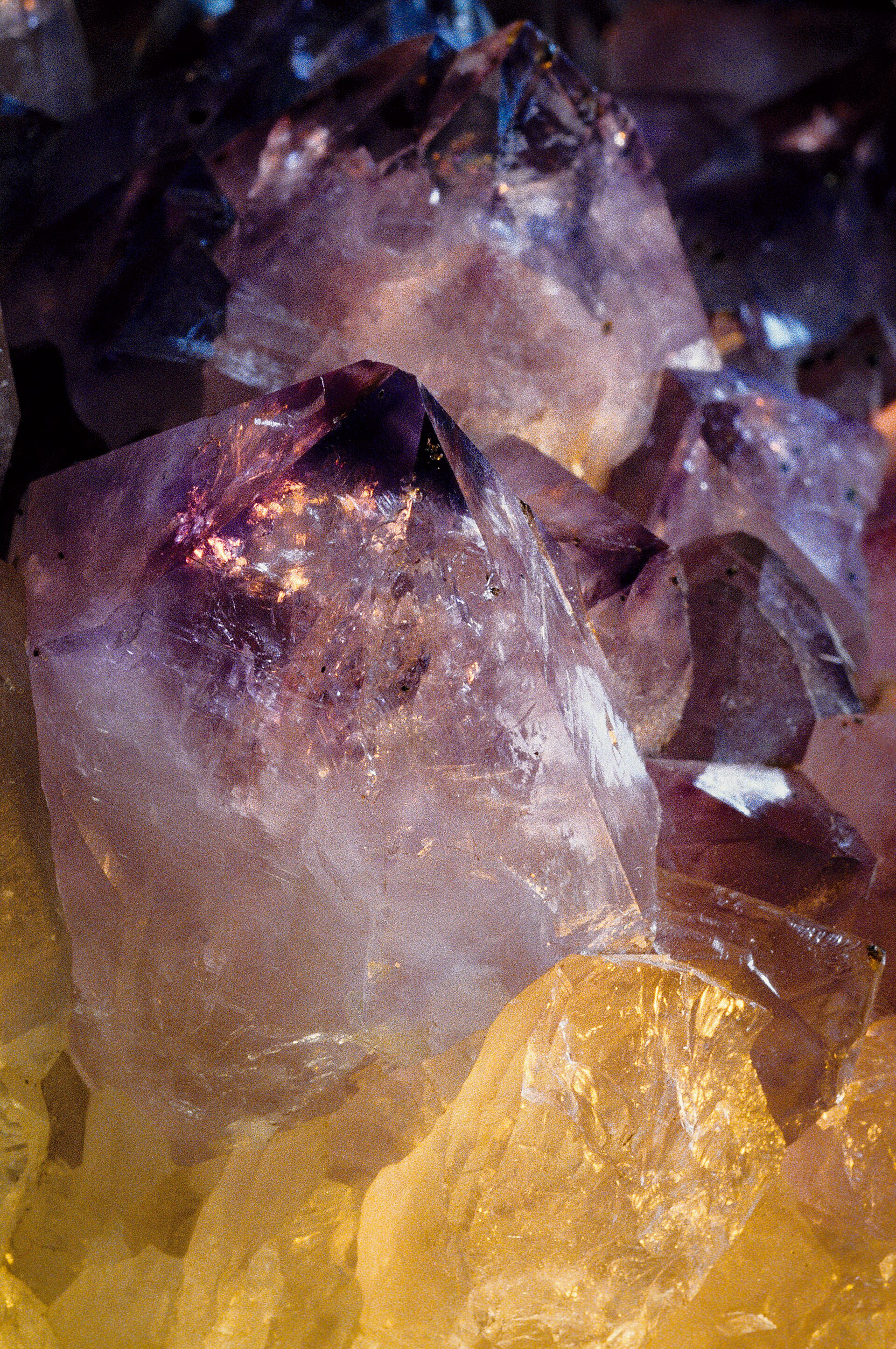 Amethyst mineral specimen — Amethyst & Quartz Crystals Close-up. Rock & mineral shop, unknown source.