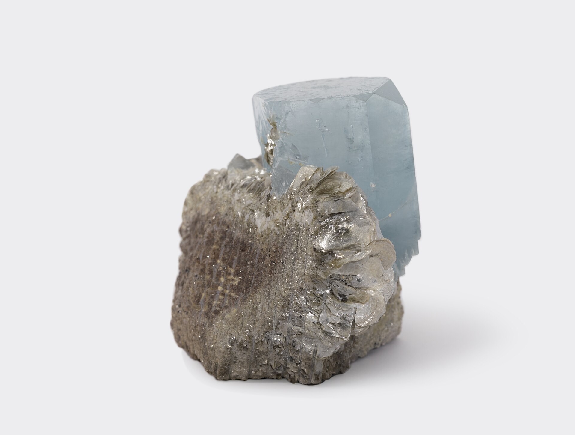 Aquamarine crystal mineral specimen — Aquamarine (Be₃Al₂(SiO₃)₆ or (Be₃Al₂Si₆O₁₈) is a variety of the beryl family and ranges from a pale 