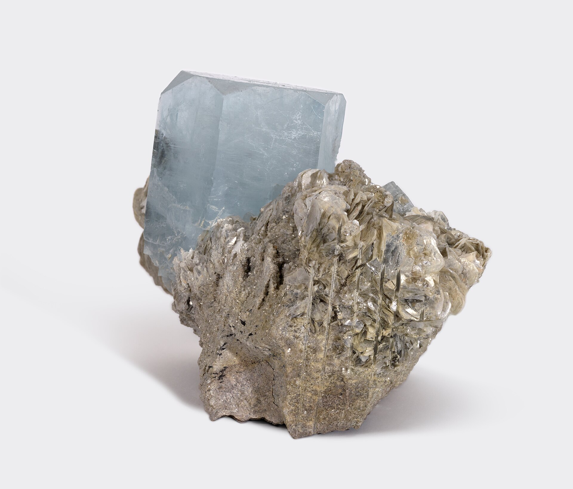 Aquamarine crystal mineral specimen — Aquamarine (Be₃Al₂(SiO₃)₆ or (Be₃Al₂Si₆O₁₈) is a variety of the beryl family and ranges from a pale 