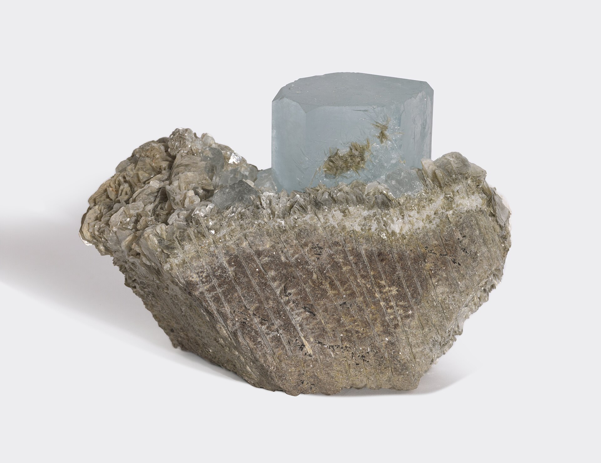 Aquamarine crystal mineral specimen — Aquamarine (Be₃Al₂(SiO₃)₆ or (Be₃Al₂Si₆O₁₈) is a variety of the beryl family and ranges from a pale 