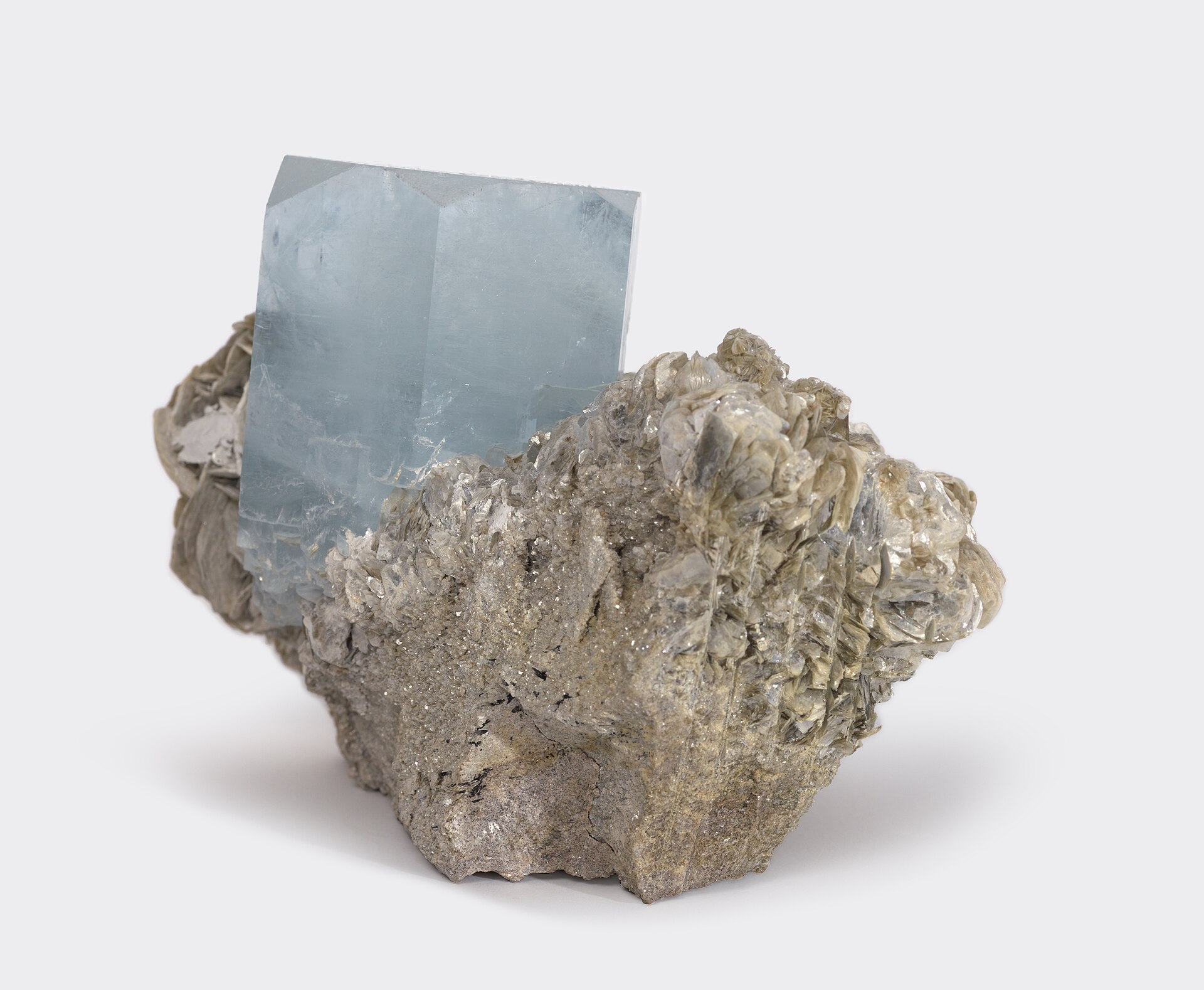 Aquamarine crystal mineral specimen — Aquamarine (Be₃Al₂(SiO₃)₆ or (Be₃Al₂Si₆O₁₈) is a variety of the beryl family and ranges from a pale 