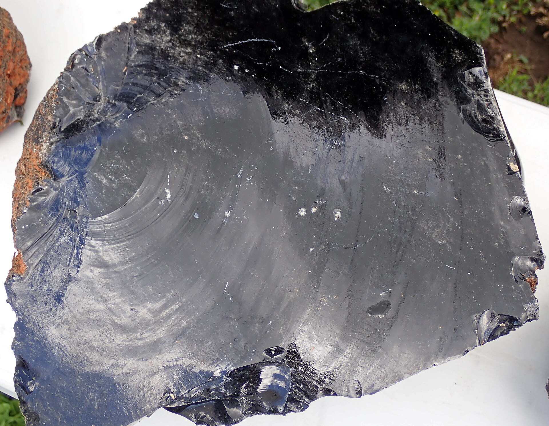 Obsidian mineral specimen — (crack surface) Obsidian is a glassy-textured, extrusive igneous rock. Obsidian is natural glass - i