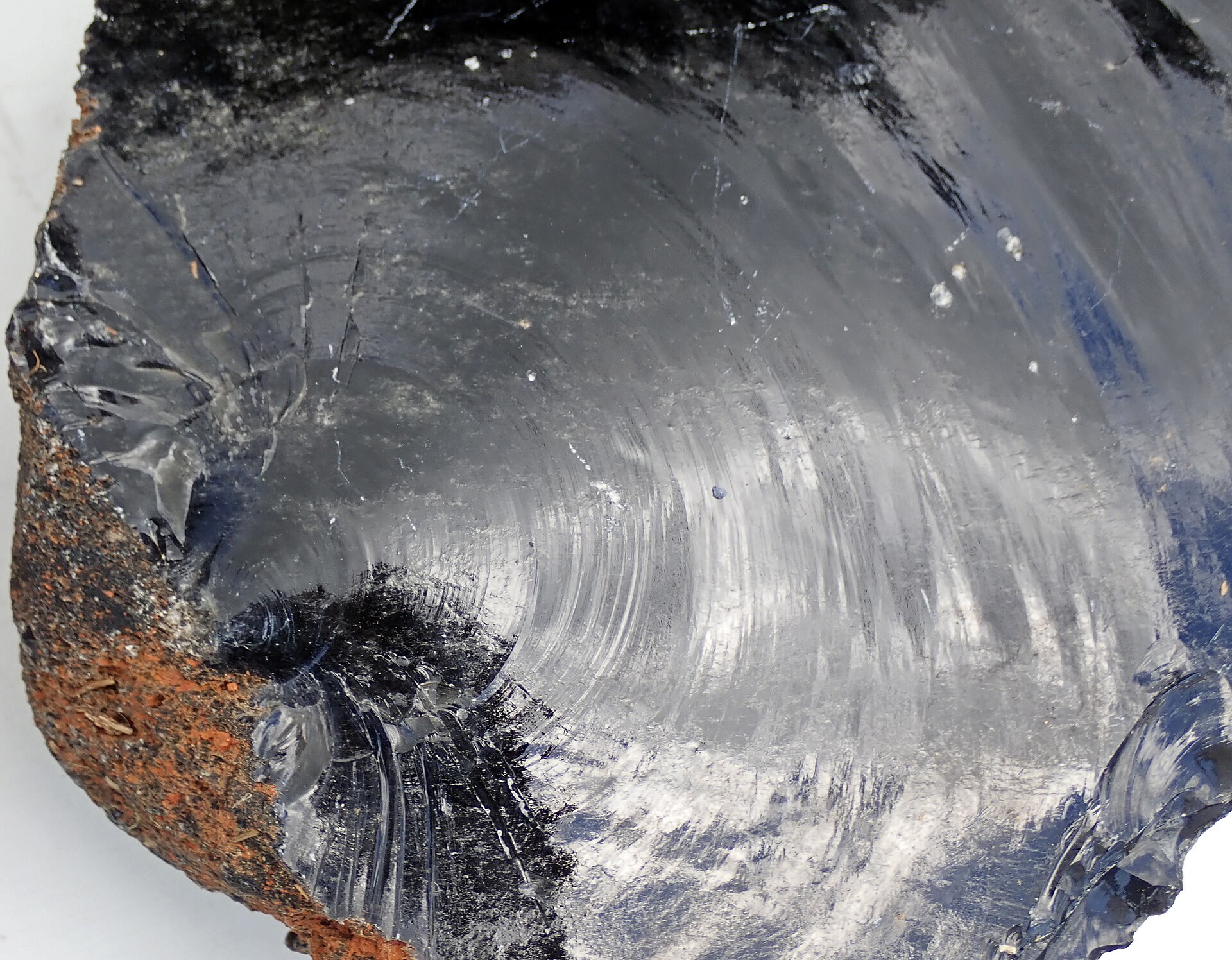 Obsidian mineral specimen — (crack surface) Obsidian is a glassy-textured, extrusive igneous rock. Obsidian is natural glass - i