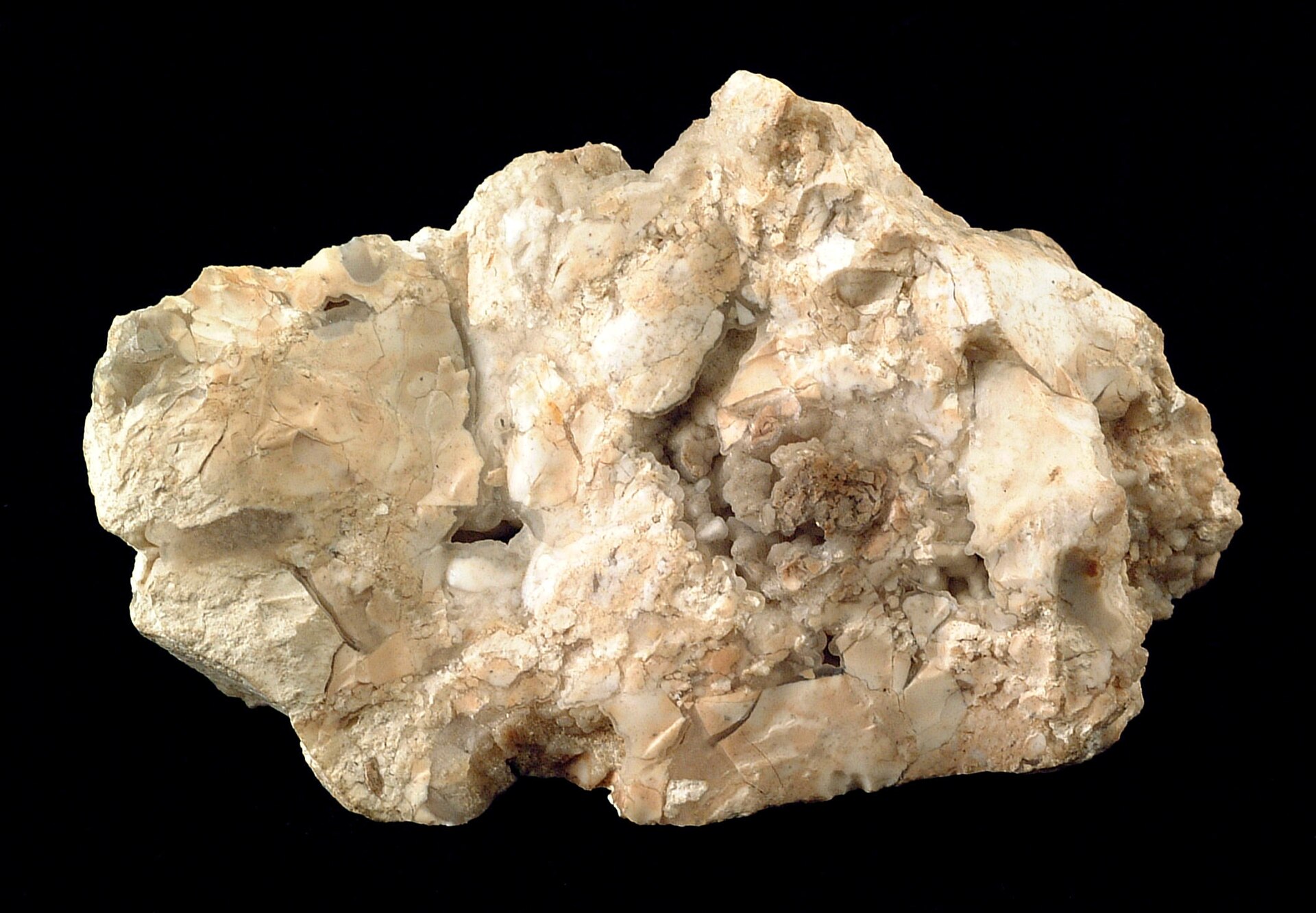Opal mineral specimen — This specimen, 11 cm across, is mostly white-tan opal. Minor quartz can be seen in a few places. Alt