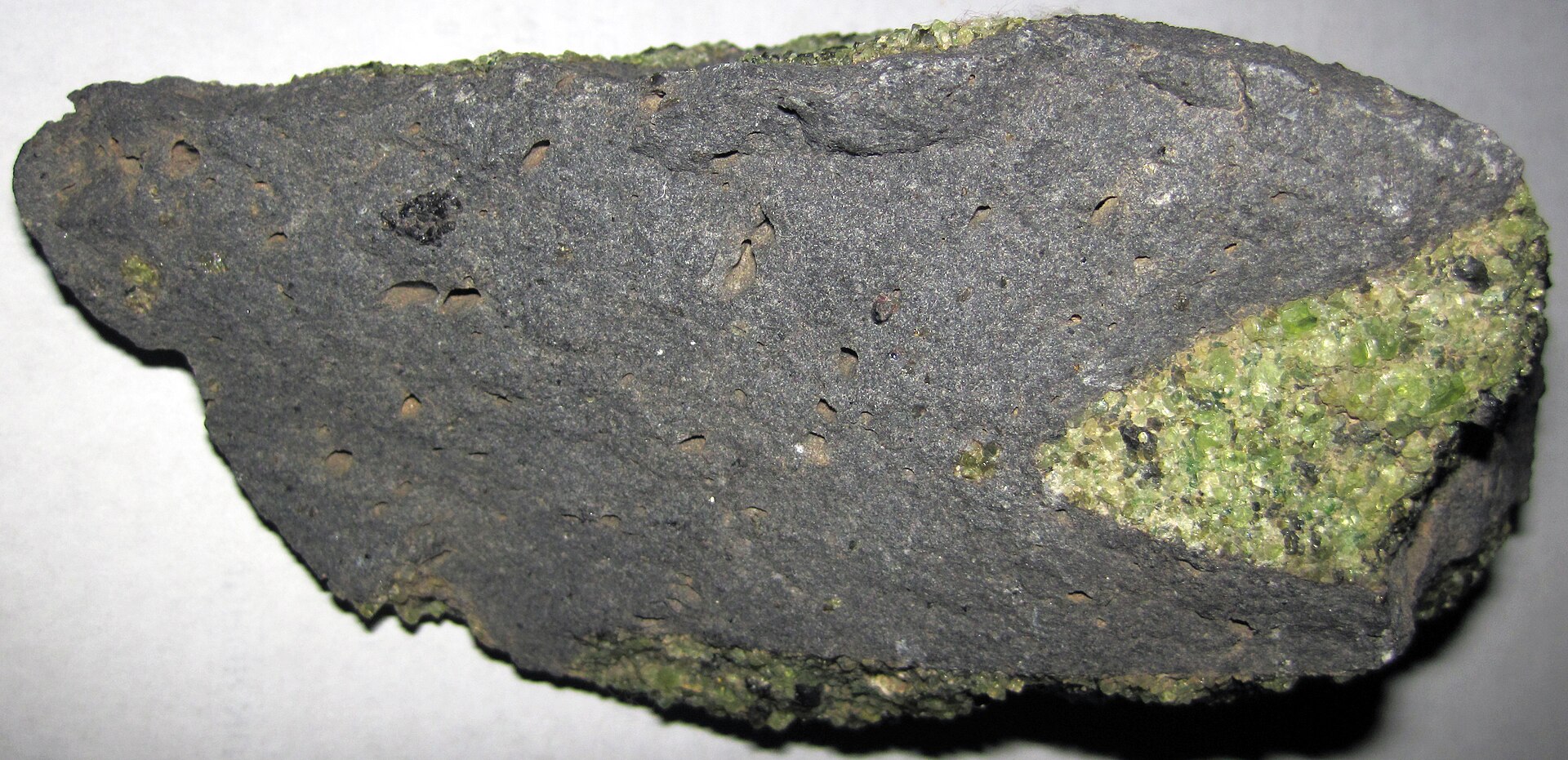 Peridot crystal mineral specimen — Peridotite mantle xenoliths in vesicular phonotephrite from the Pleistocene of Arizona, USA. Green =