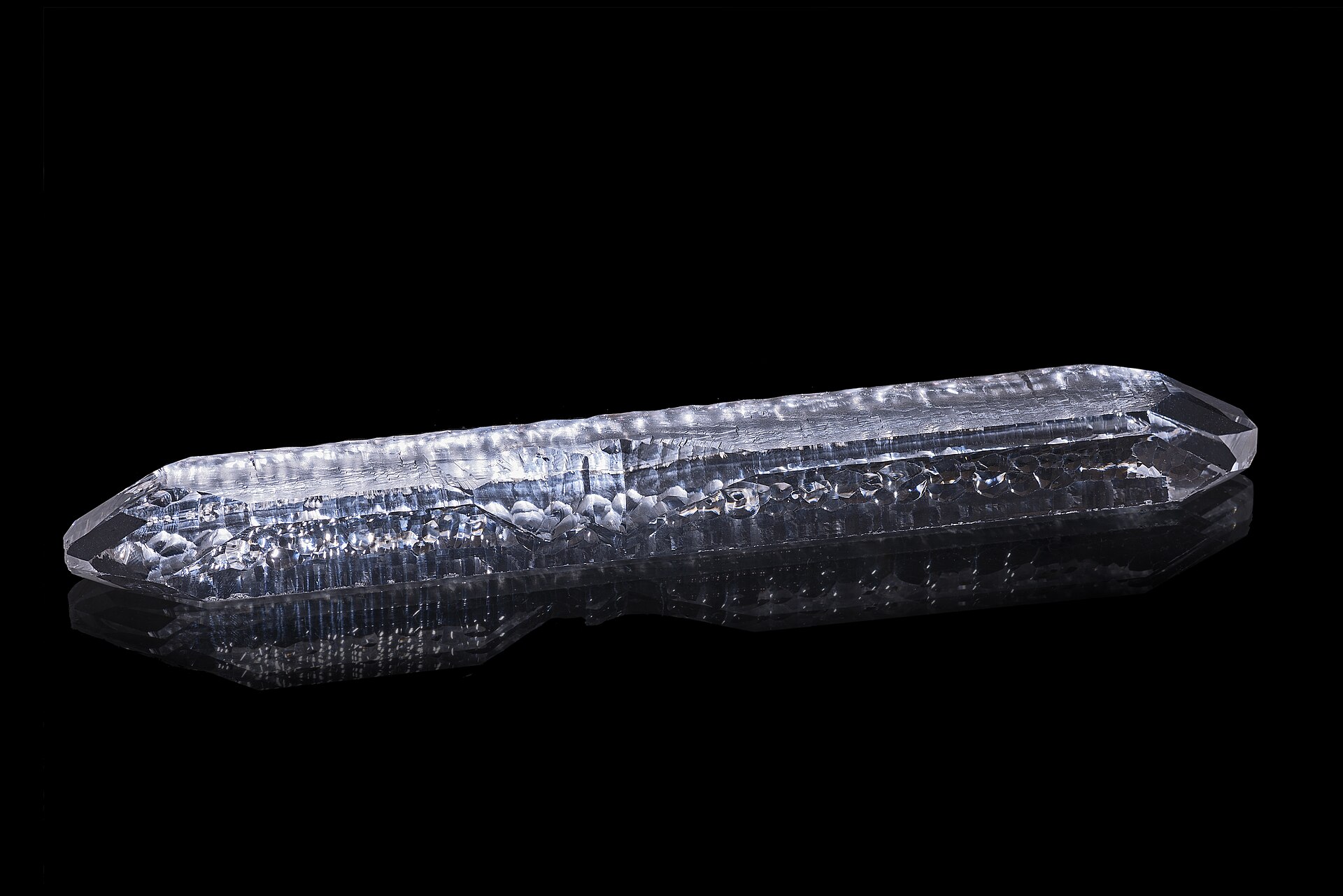 Quartz crystal mineral specimen — A single-crystal quartz bar artificially grown by the hydrothermal method. Size : 19.2 x 2.8 cm