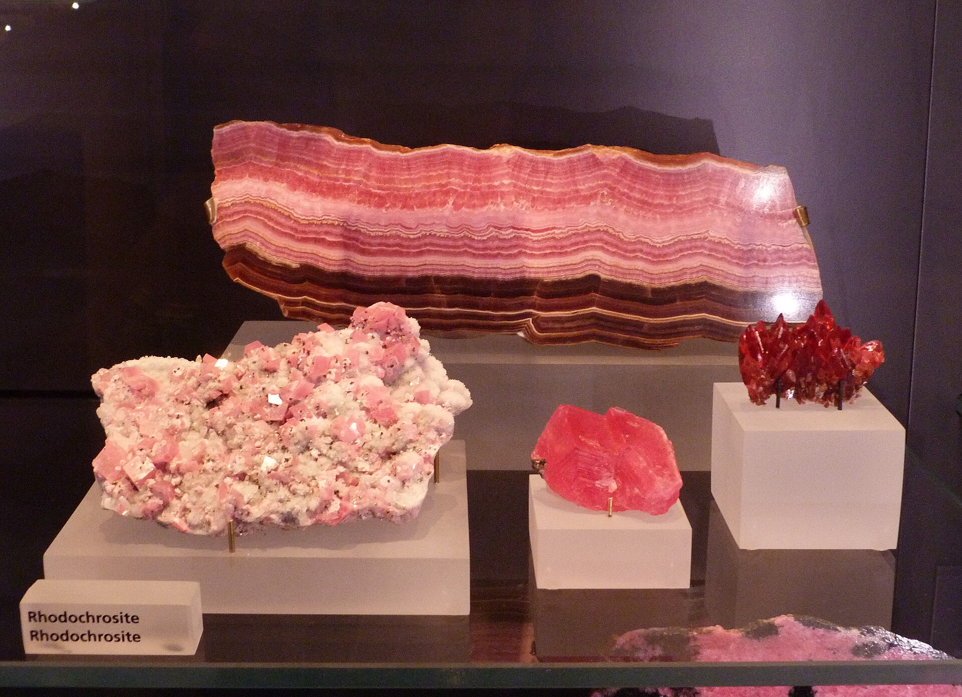 Rhodochrosite mineral specimen — Rhodochrosite in different crystallization variants. Exhibited at the Royal Ontario Museum From left