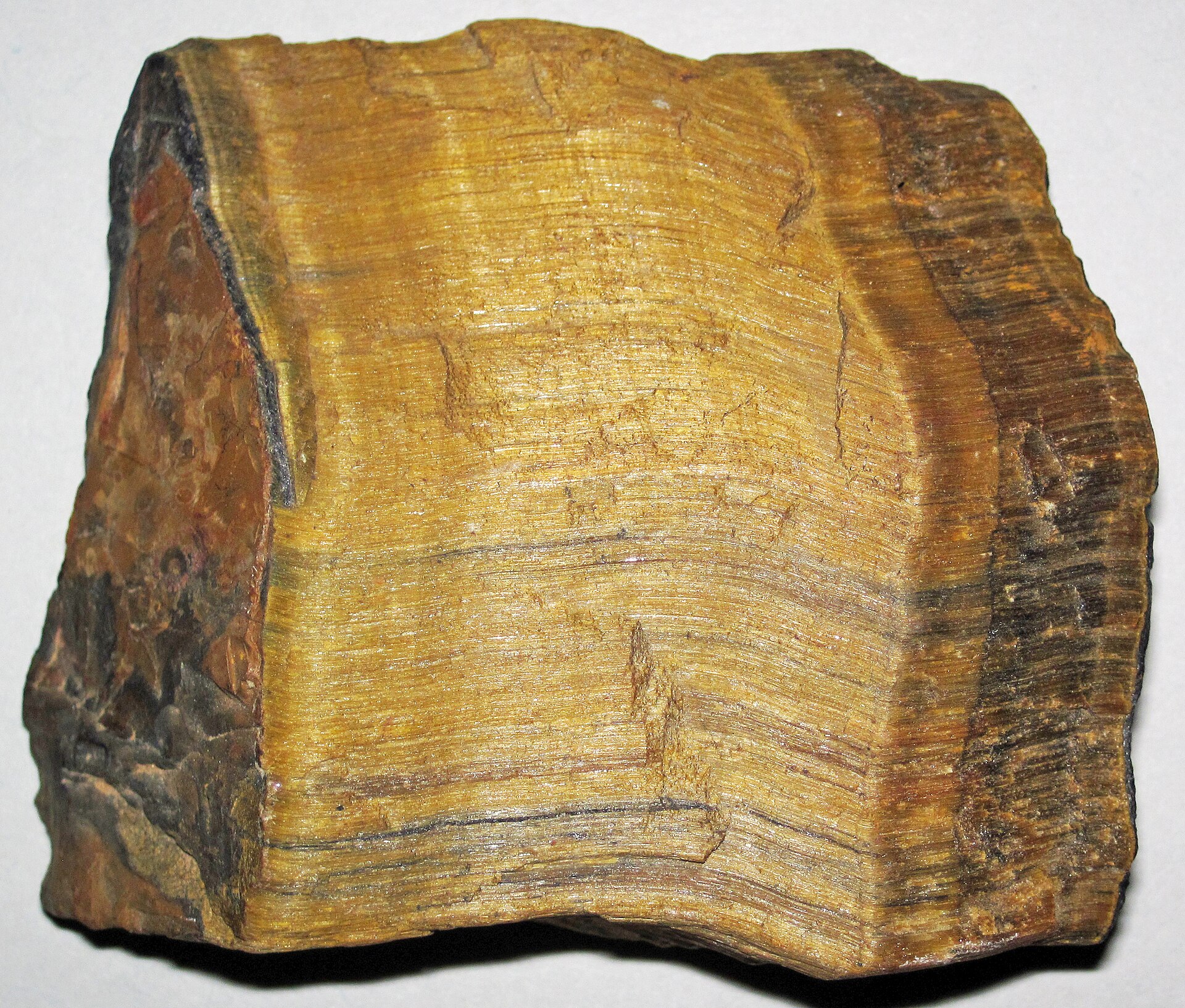 Tiger eye mineral specimen — Tiger's eye quartz (rough; ~6.1 centimeters across at its widest) A mineral is a naturally-occurring